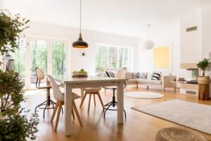 Plants in spacious white living room connected with dining hall