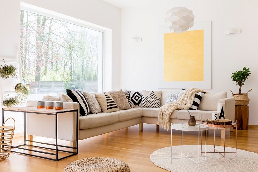 Modern interior of spacious lounge with sofa and three coffee tables