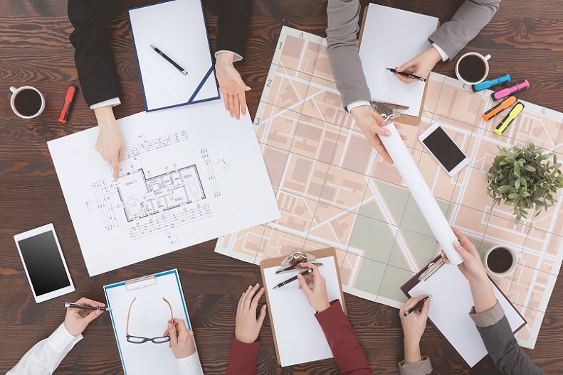 Workers of real estate agency analyzing architecture project, top view